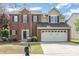 Charming two-story brick home featuring a two-car garage and professionally landscaped front yard at 9803 Forest Run Ln, Charlotte, NC 28277