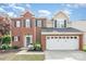 Charming two-story brick home featuring a two-car garage and professionally landscaped front yard at 9803 Forest Run Ln, Charlotte, NC 28277