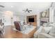 Elegant living room with a cozy fireplace, built-in shelving, and hardwood flooring at 9803 Forest Run Ln, Charlotte, NC 28277