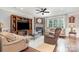 Elegant living room with a cozy fireplace, built-in shelving, and hardwood flooring at 9803 Forest Run Ln, Charlotte, NC 28277