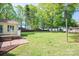 Spacious backyard features a large grassy area, mature trees, and a shed, providing ample outdoor space at 1 Horace Grigg Cir, Shelby, NC 28152