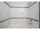 Clean bathroom with white tiled tub, shower, and dark accent trim at 1 Horace Grigg Cir, Shelby, NC 28152