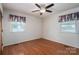 A cozy bedroom featuring hardwood floors, two windows, and a ceiling fan for comfortable living at 1 Horace Grigg Cir, Shelby, NC 28152