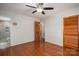 Bedroom featuring hardwood floors, ceiling fan, and open doors to the bathroom and closet at 1 Horace Grigg Cir, Shelby, NC 28152