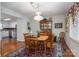 Formal dining room featuring wood table set, china cabinet, and decorative light fixture at 1 Horace Grigg Cir, Shelby, NC 28152