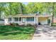 Inviting single-story brick home featuring a covered front porch and an attached carport on a sunny day at 1 Horace Grigg Cir, Shelby, NC 28152