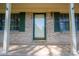 Close-up of the front entrance featuring a brick facade, a glass door and sidelight with green trim at 1 Horace Grigg Cir, Shelby, NC 28152
