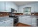 Modern kitchen boasts white cabinets, updated appliances, and stylish backsplash tiles at 1 Horace Grigg Cir, Shelby, NC 28152