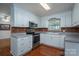 Bright kitchen featuring white cabinets, stainless steel appliances, and dark backsplash at 1 Horace Grigg Cir, Shelby, NC 28152