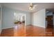 Spacious living room with hardwood floors, ceiling fan, and view into kitchen and sunroom at 1 Horace Grigg Cir, Shelby, NC 28152