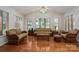 Bright sunroom with hardwood floors, wicker furniture, large windows, and a vaulted ceiling at 1 Horace Grigg Cir, Shelby, NC 28152