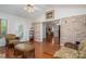 Comfortable living room with hardwood floors, wicker furniture, and an open brick archway to the dining area at 1 Horace Grigg Cir, Shelby, NC 28152