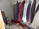 Walk-in closet is filled with hanging clothes and items on the floor at 107 N Rudisill Ave, Cherryville, NC 28021