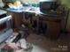 Undersink of kitchen with floor debris and missing cabinet doors at 107 N Rudisill Ave, Cherryville, NC 28021