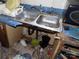 Kitchen sink with double basin and some debris on the floor and cabinets at 107 N Rudisill Ave, Cherryville, NC 28021
