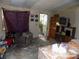 Living room featuring an armchair, doorway to porch, TV stand, and window at 107 N Rudisill Ave, Cherryville, NC 28021