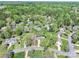 An aerial view of a single-Gathering home surrounded by lush trees in a quiet neighborhood at 111 Woodfern Pl, Mooresville, NC 28115