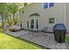 Inviting backyard featuring a patio with seating, a well-manicured lawn, and mature trees at 111 Woodfern Pl, Mooresville, NC 28115