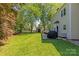 Spacious backyard with lush green grass, mature trees, and a patio area for outdoor enjoyment at 111 Woodfern Pl, Mooresville, NC 28115