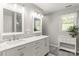 Bright bathroom with double vanity, marble countertop, and decorative window with natural light at 111 Woodfern Pl, Mooresville, NC 28115