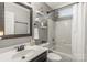 Bathroom with dark fixtures, tub and shower combination, and decorative mirror at 111 Woodfern Pl, Mooresville, NC 28115