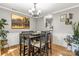 Dining area with wood floors, traditional decor, chandelier, and large landscape painting at 111 Woodfern Pl, Mooresville, NC 28115