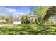 Inviting two-story brick home featuring a lush green lawn and beautiful landscaping with mature trees at 111 Woodfern Pl, Mooresville, NC 28115