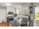 Bright kitchen features white cabinets, gray countertops, stainless steel appliances, and a farmhouse sink at 111 Woodfern Pl, Mooresville, NC 28115