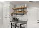 Inviting kitchen features open shelving, subway tile backsplash, and well-organized storage solutions at 111 Woodfern Pl, Mooresville, NC 28115