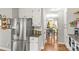 View of the kitchenette with stainless steel appliances adjacent to the dining area at 111 Woodfern Pl, Mooresville, NC 28115