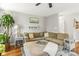 Comfortable living room featuring a sectional sofa, a decorative rug, and hardwood floors at 111 Woodfern Pl, Mooresville, NC 28115