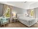 Serene main bedroom featuring neutral colors, a tufted headboard, and lots of natural light at 111 Woodfern Pl, Mooresville, NC 28115