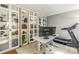 Bright home office with glass cabinets, desk, treadmill and neutral color palette at 111 Woodfern Pl, Mooresville, NC 28115