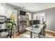Home office featuring a treadmill, white desk, gray walls, hardwood floors, and ample natural light at 111 Woodfern Pl, Mooresville, NC 28115