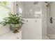 Modern shower with glass enclosure, rainfall showerhead, and marble tile walls at 111 Woodfern Pl, Mooresville, NC 28115