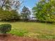 Green backyard with a wooden fence at 1121 Setter Se Ln, Concord, NC 28025