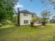 Spacious backyard with lush lawn and mature trees, offering a private setting at 1121 Setter Se Ln, Concord, NC 28025