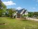 Large backyard featuring a screened-in porch and wrought iron fence at 1121 Setter Se Ln, Concord, NC 28025