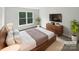 Modern bedroom with stylish decor, platform bed, and a flat-screen TV at 1121 Setter Se Ln, Concord, NC 28025
