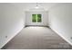 Spacious, naturally lit bedroom with neutral carpet and ceiling fan at 1121 Setter Se Ln, Concord, NC 28025