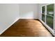 Bedroom with gleaming wood floors and light streaming through a large window at 1121 Setter Se Ln, Concord, NC 28025