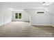 Expansive bonus room with neutral carpet and natural light from two windows at 1121 Setter Se Ln, Concord, NC 28025