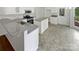 Bright kitchen with white cabinetry, stainless steel appliances, and granite countertops at 1121 Setter Se Ln, Concord, NC 28025