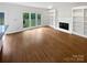 Spacious living room showcasing gleaming hardwood floors, built-in shelving, and natural light at 1121 Setter Se Ln, Concord, NC 28025