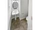 Small powder room with pedestal sink, round mirror, and vinyl flooring at 1121 Setter Se Ln, Concord, NC 28025