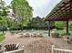The back yard features a beautiful pool, patio, lounge chairs, and an outdoor dining area at 1126 Concord Rd, Davidson, NC 28036