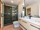 The bathroom has a modern vanity with black fixtures, a glass shower, and blonde wood floors at 1126 Concord Rd, Davidson, NC 28036
