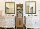 Double sink vanity with decorative mirrors and a central storage shelf, complemented by elegant finishes at 1126 Concord Rd, Davidson, NC 28036