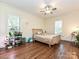 Charming bedroom with natural light, hardwood floors, and a cozy wicker bed with plants at 1126 Concord Rd, Davidson, NC 28036