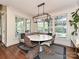 Dining area with natural light, hardwood floors, modern light fixture, and outdoor views at 1126 Concord Rd, Davidson, NC 28036